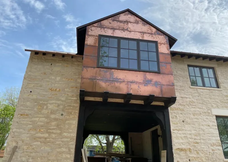 Copper metal panel facade on a stone building for Skylight Installation in Big Bear Lake